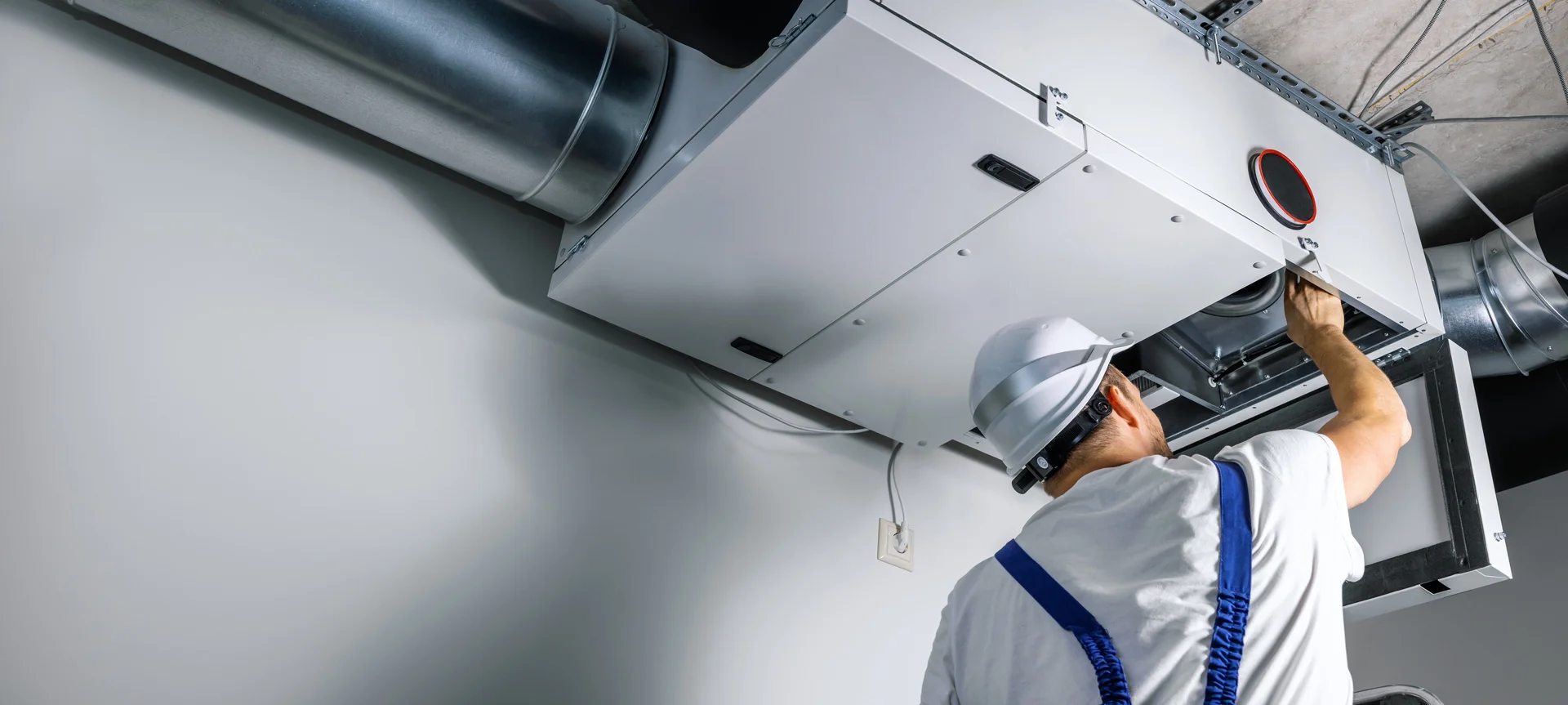 Male worker finishing air duct cleaning process